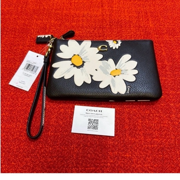 Coach Handbags - Coach Black Wristlet with White Daisy Design
